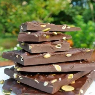 Salted Dark Chocolate Bark with Pumpkin Seeds stacked on a plate