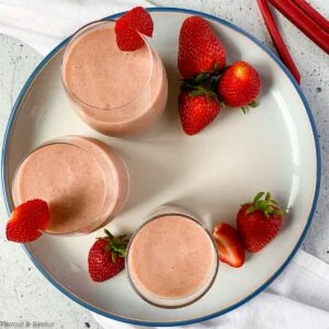 overhead view of 3 glasses of strawberry rhubarb smoothie