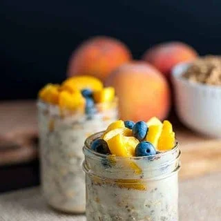 Peach and Blueberry Overnight Oats in two small jars..