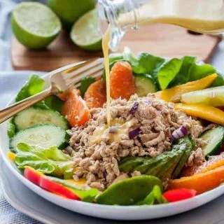 Pouring Citrus Vinaigrette on Caribbean Shredded Jerk Chicken Salad_