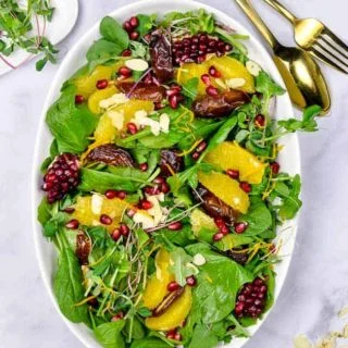 Spinach Salad with Oranges Dates and Pomegranate overhead view