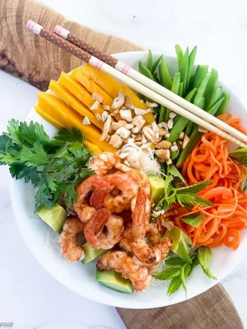 Vietnamese Prawn Noodle Bowl on a board with chopsticks.