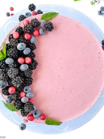 Blackberry Cheesecake Ice Cream Cake decorated with blackberries and blueberries
