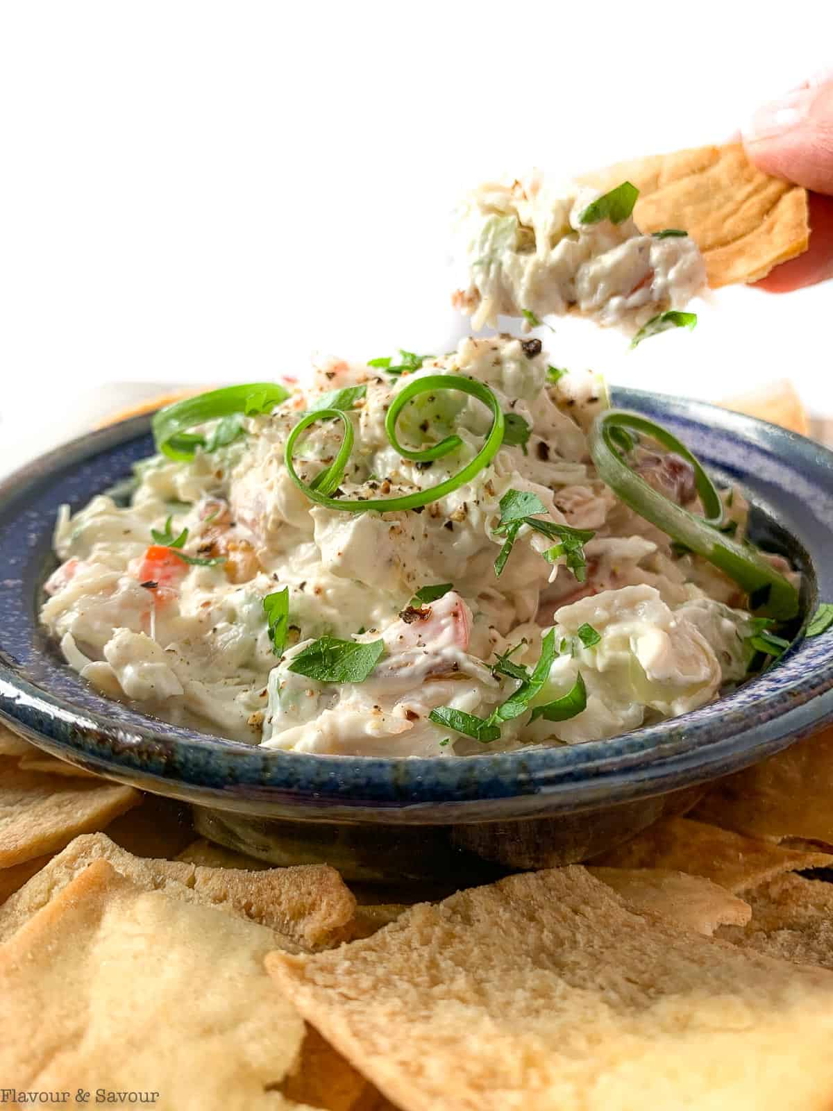 A scoop of cold crab dip on a cracker.