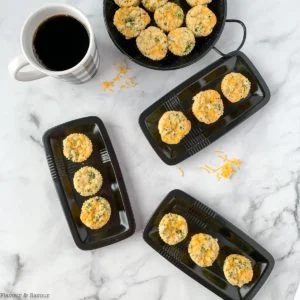 Gluten-free Broccoli Cheddar Muffins on small black plates.