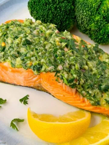 air fryer chimichurri salmon on a plate with lemon wedges