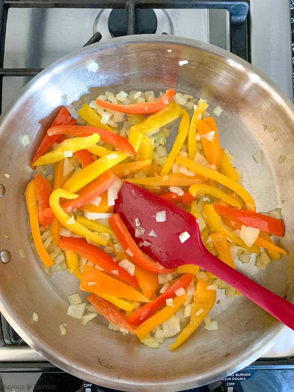 onions and peppers in a skillet