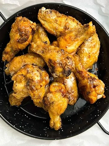 Air Fryer Hot Honey Wings in a dark serving dish.