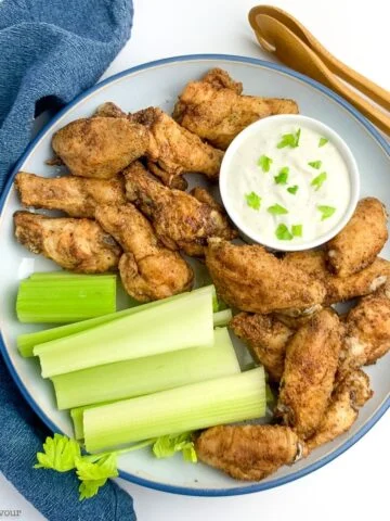 A platter of chicken wings and celery for Game Day snacks.